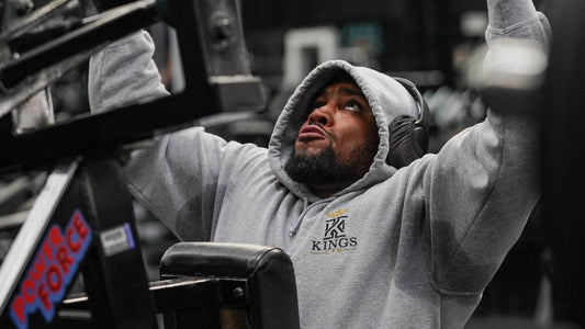 Picture of a man wearing a hoodie to the gym.