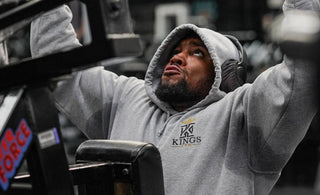 Picture of a man wearing a hoodie to the gym.