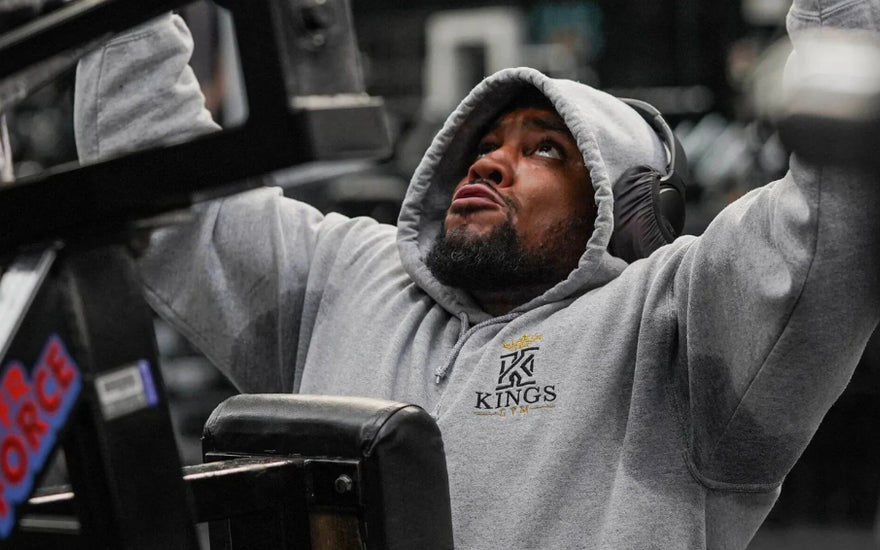 Picture of a man wearing a hoodie to the gym.